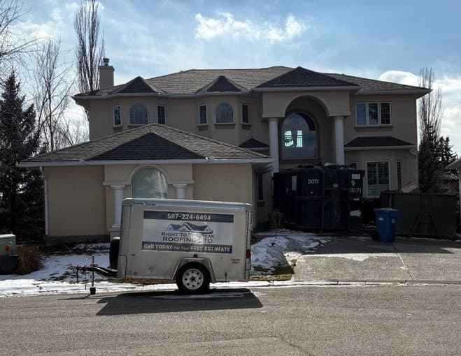 Peakline Roofing & Exteriors professional trailer at a luxury home jobsite in Calgary