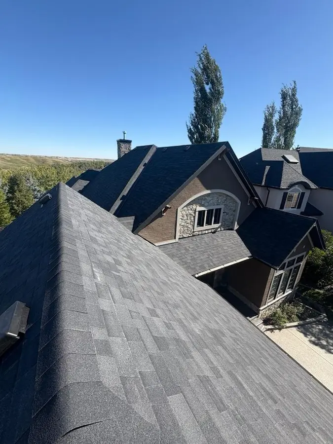 Complete residential roof replacement by Peakline Roofing & Exteriors including tear-off and new shingle installation in Calgary